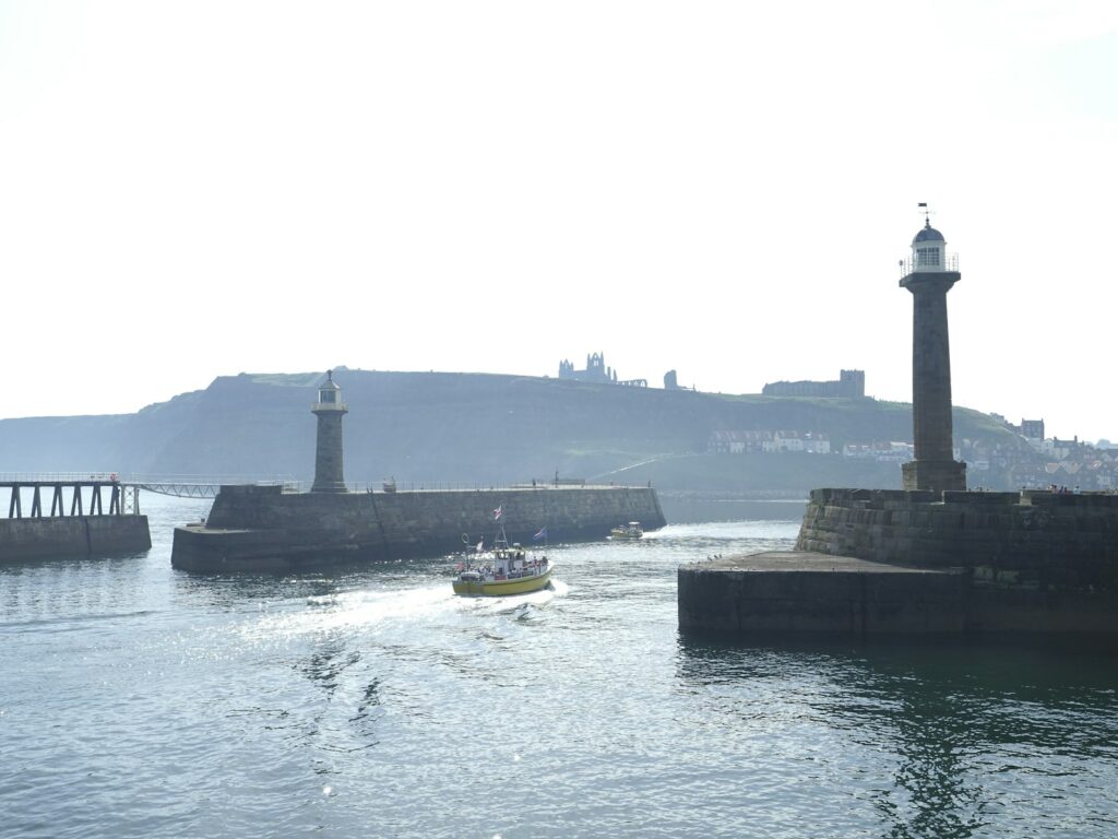 Whitby harbour piers with the abbey on the headland behind